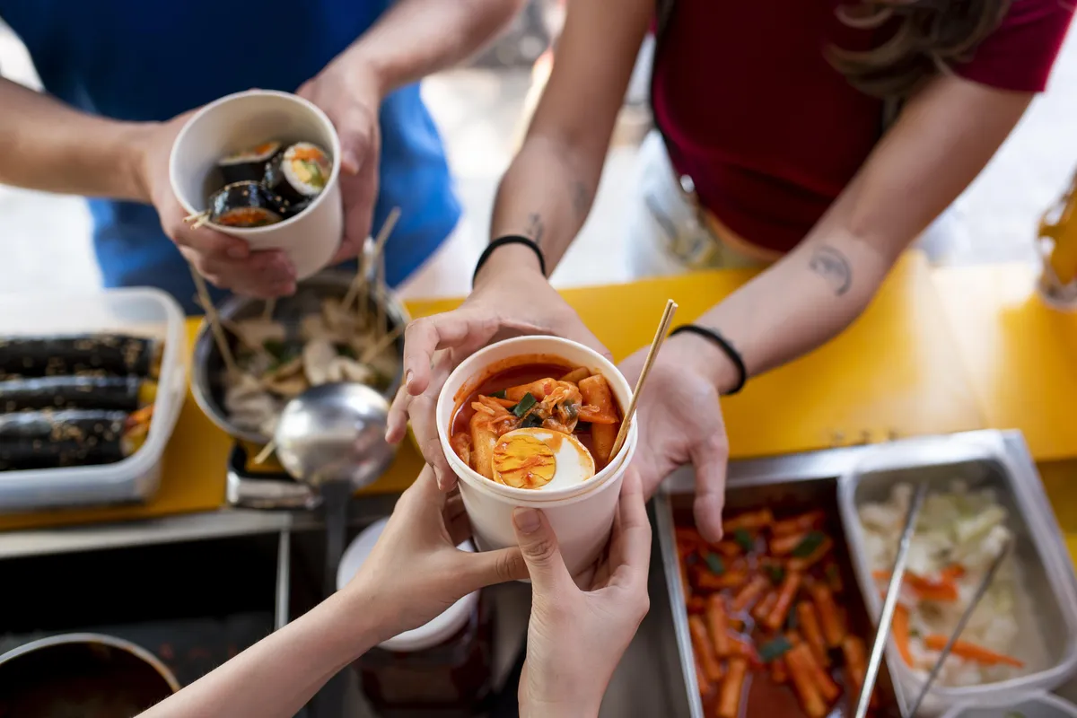 close-up-hands-holding-cup-with-food.webp